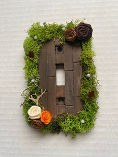 a house made out of wood with moss and flowers