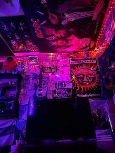 a room filled with posters and neon lights