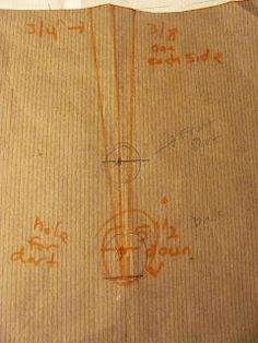 the back side of a cardboard box with drawings on it and writing in orange ink