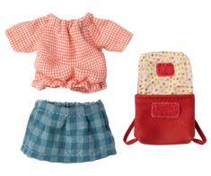 two doll clothes and a purse on a white background