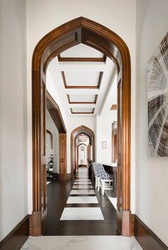 an archway leading into a hallway with black and white checkered flooring on both sides