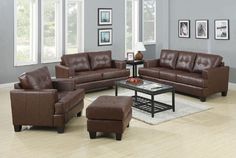 a living room with brown leather furniture and pictures on the wall