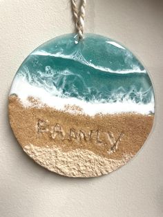 Family In Sand Ornament  Add a splash the beach to your Christmas tree or hang it anywhere you like. This beautiful one of a kind ornament features FAMILY written in the sand and ocean waves on a 4-inch acrylic disc, not glass. This is a nice feature for kid/pet friendly homes! The water is resin has mica powder for a nice sparkle finish. Small gift bag included, see pictures.  This listing is for 1 ornament. This ornament is a one of a kind. The ornament pictured is the one you will receive. I Family Written, Resin Tips, Beach Resin, Beach Christmas Ornaments, Coastal Ornament, Beach Ornaments, Ornament Family, Beach Christmas, Small Gift Bags