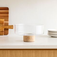 a bowl sitting on top of a counter next to plates