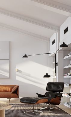 a modern living room with two leather chairs and a large lamp on the wall above it