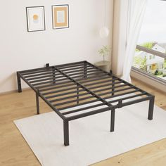 a metal bed frame in front of a window