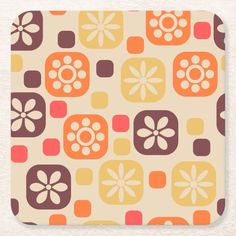 an orange and brown flower pattern coaster