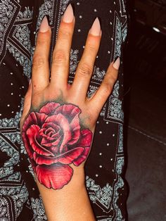 Detailed rose tattoo in color Rose Name Hand Tattoo, Rose On Hand Tattoo, Red Rose Tattoo Black Skin, Red Rose Hand Tattoo, Rose Hand Tattoo Woman, Rose Hand Tattoo Color, Black Rose Hand Tattoo For Women, Coloured Rose Tattoo, Dark Pink Rose Tattoo