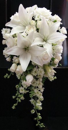 a bouquet of white flowers sitting on top of a table