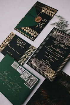 black and gold wedding stationery with green envelopes