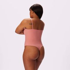 The Universal fabric you love now in a sleek, sexy bodysuit that molds to your body and flatters your curves. Featuring dainty cami-style straps that show you off. Now in Pink Canyon <3 Second-skin Bodysuit With Spaghetti Straps And Built-in Bra, Second-skin Camisole Bodysuit With Built-in Bra, Lined Bodysuit Camisole, Camisole Bodysuit With Lined Body, Solid Camisole Bodysuit With Lined Body, Shapewear Bodysuit With Seamless Construction, Seamless Backless Shapewear Bodysuit, Solid Color Shapewear Bodysuit With Tank Straps, Solid Color Cami Bodysuit With Lined Body