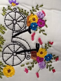 a close up of a piece of cloth with flowers and a bike design on it