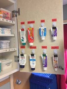 an organized medicine cabinet with toothpaste on it