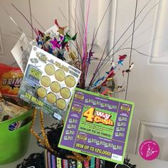 a basket filled with cookies and candy on top of a table next to a sign