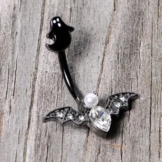 Clear Gem Black Ghost Vampire Bat Halloween Double Mount Belly Ring Start your Halloween shopping with a little treat for yourself with this 14 gauge navel jewelry with tons of holiday spirit. Made with a 3/8" black PVD over 316L surgical grade stainless steel curved barbell, this navel piercing features a black ghost top charm and a vampire bat bottom charm set with clear gems and a white orb for very spooky style.Specifications14 Gauge (1.6mm), 3/8" (10mm), Black PVD over 316L Surgical Grade S Gothic Piercings For Halloween Gift, Black Piercings For Halloween Gift, Silver Body Jewelry For Halloween, Halloween Silver Body Jewelry Gift, Black Ghost, Jewelry Promotion, Spooky Style, Bat Halloween, Navel Jewelry