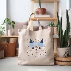 This farmers market-style canvas tote is a great for every day use or as a gift for someone special. You can use it for a trip to the market or for your day at the spa or Yoga studio.  We use a high quality professional direct to garment (DTG) process on our products, this means fabric-grade ink is printed directly onto the garment blending with the fibers. This process allows us to achieve a vintage style look on many of our designs, and a feel that is similar to screen-printing (which avoids t Daily Use Rectangular Canvas Bag With Cat Design, Beige Bags With Animal Design For Everyday Use, White Cat Print Bag For Everyday Use, Eco-friendly Tote Bag With Cat Design, Daily Use Cat Print Canvas Tote Bag, Everyday Rectangular Bag With Cat Print, Everyday Tote Shoulder Bag With Cat Design, Eco-friendly Cat Design Tote Bag, Eco-friendly Rectangular Bag With Cat Design