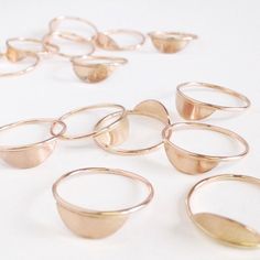 "A plate of metal is attached to a smooth band of metal to form a ring perfect on its own and striking when doubled up, especially in contrasting metals! *measures 0.5\" wide *1mm wide band *sold individually *available in 14k yellow gold fill, 14k rose gold fill, or sterling silver *hypoallergenic, nickel-free, and lead-free *handmade in Portland, Oregon, USA, from recycled metals Need to find your ring size? http://favorjewelry.com/ringsize More stacking rings: http://etsy.me/1HZVcwK More jewe Rose Gold Round Midi Rings, Dainty Rose Gold Metal Rings, Minimalist Rose Gold Metal Ring, Hand Forged Metal Rings, Minimalist Hand Forged Metal Rings, Hand Forged Minimalist Metal Rings, Half Moon Ring, Gold Shield, Shield Ring