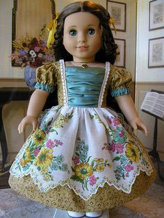 the doll is wearing a dress with flowers on it