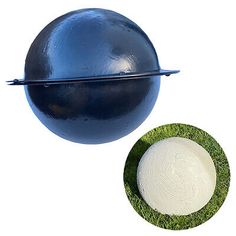 a large blue ball sitting on top of a green field next to a white disc