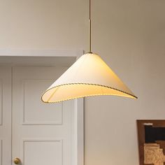 a light hanging from the ceiling in a room