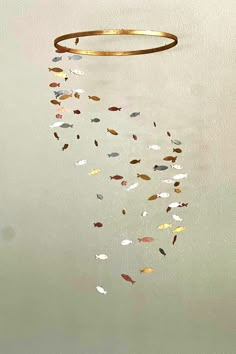 a painting of a gold ring hanging from the ceiling with small fish swimming in it