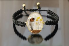 "✓ Personalized Hair Locket Cremation Bracelet With Flower & Soil/Ashes For Women, Our Solid 925 Sterling Silver Bracelet with %100 hand crafted, gold workmanship is specially produced for you, Jewelry made with love for your special occasions. ---● B R A C E L E T  ∙  D E T A I L S ●--- * The Balls In The Chain and Case Of The Hair Is SOLID 925 STERLING SILVER. * The Top Of The Hair is made of UV stable resin. And your hair will be safe in it. * Current production time is 4 to 8 business days f Unique Resizable Bracelets For Gift, Elegant Handmade Braided Bracelets As Gifts, Elegant Handmade Braided Bracelets For Gifts, Handmade Nature-inspired Bracelets As Gifts, Unique Braided Bangle Bracelets As Gifts, Unique Braided Bangle Bracelets For Gifts, Handmade Braided Bangle Bracelets As Gifts, Handmade Gold Nature-inspired Bracelets, Hand-wrapped Braided Bracelet As Gift