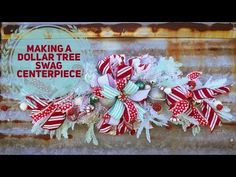 a red and white christmas wreath sitting on top of a rusted metal wall next to a sign that says making a dollar tree swag centerpiece