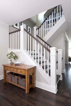 an empty room with a table and stairs