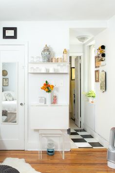 a living room filled with furniture and decor on top of a hard wood floored floor