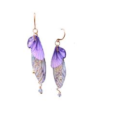 two purple and gold earrings with flowers hanging from it's ear wires on a white background