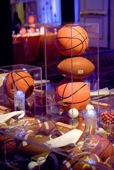 two basketballs are stacked on top of each other in a display case at a sports museum