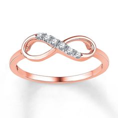 a rose gold ring with two diamonds on it