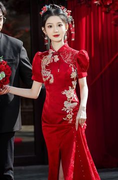 The dress adorned with a stunning phoenix print, adding an elegant, heritage-inspired aesthetic. The phoenix motif symbolizes prosperity and good fortune, making this gown a wonderful choice for special occasions. Whether you're looking for a showstopping wedding dress or a special event outfit, this red qipao offers the perfect fusion of time-honored Chinese craftsmanship and modern stylistic flair. Pair it with delicate accessories to create a refined look, or amp up the glamour with bold jewe Chinese Print Dress, Red Brocade Wedding Dress, Short Sleeve Dresses For Wedding And Festivals, Elegant Gown For Ceremony And Festivals, Elegant Red Ceremonial Dress, Elegant Dresses For Ceremonies And Festivals, Elegant Dresses For Ceremony And Festivals, Traditional Red Cheongsam For Wedding, Traditional Red Wedding Cheongsam