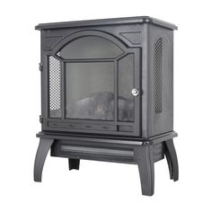 a black fireplace with a glass door on the top and bottom shelf, in front of a