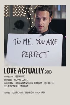 a man holding a sign that says to me, you are perfect love actually 2003