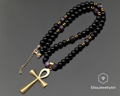 Brass Ankh Cross Necklace Natural Amethyst & Black Onyx Beaded Necklace Anger Gemstone Necklace Protective Necklace -ALL THE PRODUCTS AT ELISAJEWELRYART ARE HANDMADE AND MADE WITH NATURAL BEADS. -WHAT DOES THE ONYX STAND FOR    A powerful protection stone, Black Onyx absorbs and transforms negative energy, and helps to prevent the drain of personal energy. Black Onyx aids the development of emotional and physical strength and stamina, especially when support is needed during times of stress, con Black Amethyst Gemstone Beads Jewelry, Black Amethyst 8mm Bead Jewelry, Black Amethyst Beads Jewelry 8mm, Black Amethyst Gemstone Beads Necklace, Spiritual Black Cross Beaded Necklace, Black Gemstone Beaded Necklace With Spiritual Style, Spiritual Black Beaded Gemstone Necklaces, Spiritual Black Beaded Gemstone Necklace, Spiritual Onyx Cross Jewelry