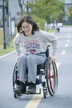 a woman in a wheel chair on the street