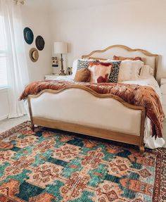 a large bed sitting in the middle of a bedroom