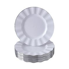 two white plates stacked on top of each other in front of a white background with silver foil