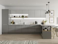 a modern kitchen with grey cabinets and white counter tops, an area rug on the floor