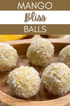 mango bliss balls on a wooden plate with oranges in the background and text overlay