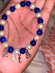 Beautiful Zeta Phi Beta bracelet. Letters are made out Zinc alloy, lead and nickel free. Bracelet size is a standard 7 1/2, if a different size is needed please send a message. Metal Stretch Bracelet With Round Beads For Gift, Metal Beaded Stretch Bracelet As A Gift, Customized Silver Bracelets With Round Beads, White Metal Stretch Bracelet For Gifts, White Metal Stretch Bracelet For Gift, Personalized White Metal Bracelets, Nickel Free Stretch Bracelet Gift, Metal Pearl Bracelet With Round Beads As Gift, Metal Beaded Pearl Bracelet As A Gift