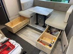 the inside of a camper with drawers on each side and a table in the middle