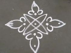 an intricate design is drawn on the ground with white chalk and watercolor pencils