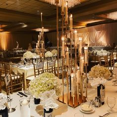 the tables are set with white and gold decorations