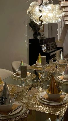 the table is set with silver and gold plates, napkins, and party hats