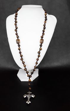 A very elegant 5 decade rosary that is shaped around the gold base. Created by triple-A Tigers Eyes gemstones, a large stainless silver steel cross and by combing a special knotted construction pattern that goes bead by bead; this rosary is meant to distinguish itself from the rest and to strengthen your faith during your prayers. Rosary: 5 Decade Rosary Rosary Necklace Yes Blessed: Yes Base Materials: Triple-A high quality Tigers Eye gemstones, a Stainless Silver Steel Cross and a special knott Catholic Rosary, Steel Cross, Rosary Bracelet, Rosary Necklace, Rosary Catholic, Tigers Eye Gemstone, Tiger Eye Beads, Tigers Eye, Ancient Greece