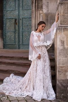 a woman in a wedding dress leaning against a wall