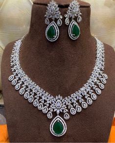 This absolutely stunning and elegant necklace set comes with dark green and white cubic zirconia encrusted stones on a silver base. This set come with necklace and earrings. Absolutely beautiful snd a must have. Would make a lovely anniversary or valentines gift.  This eye catching unique ethnic jewellery set is ideal for any traditional attire  Wear this with a saree , party wear on any festival or special occasions. This piece is readily available for immediate dispatch. Please note as this is Elegant Hand Set Emerald Diamond Necklace, Hand Set Emerald Necklace With Cubic Zirconia For Party, Elegant Hand-set Emerald Diamond Necklace, Hand Set Cubic Zirconia Emerald Necklace For Party, Hand-set Cubic Zirconia Emerald Necklace For Party, Silver American Diamond Jewelry With Stone Setting, Elegant Green Diamond Necklace Hand Set, Elegant Green Hand Set Diamond Necklace, Elegant Silver Bridal Necklace With Stone Setting