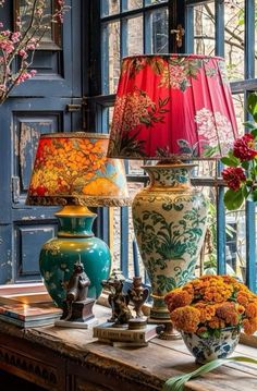 vases and lamps on a table in front of a window